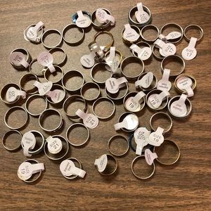 A big lot of 50 assorted rings/assorted sizes, many are stainless steel